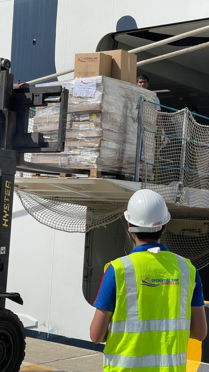 Forklift loading palletised stores aboard a cruise vessel at a UAE cruise terminal