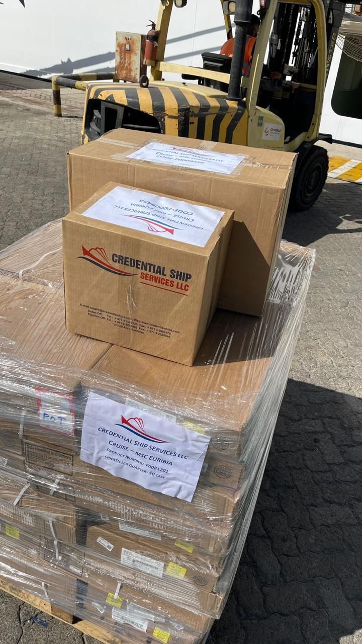 Credential Ship Services own-branded cartons palletised and labelled per vessel, ready for loading aboard a cruise vessel
